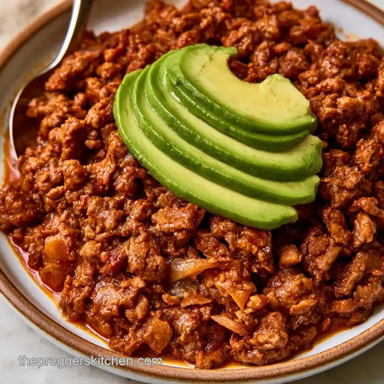 A colorful ceramic bowl filled with tender beef, sliced avocado, and bright corn kernels over a bed of fluffy white rice.