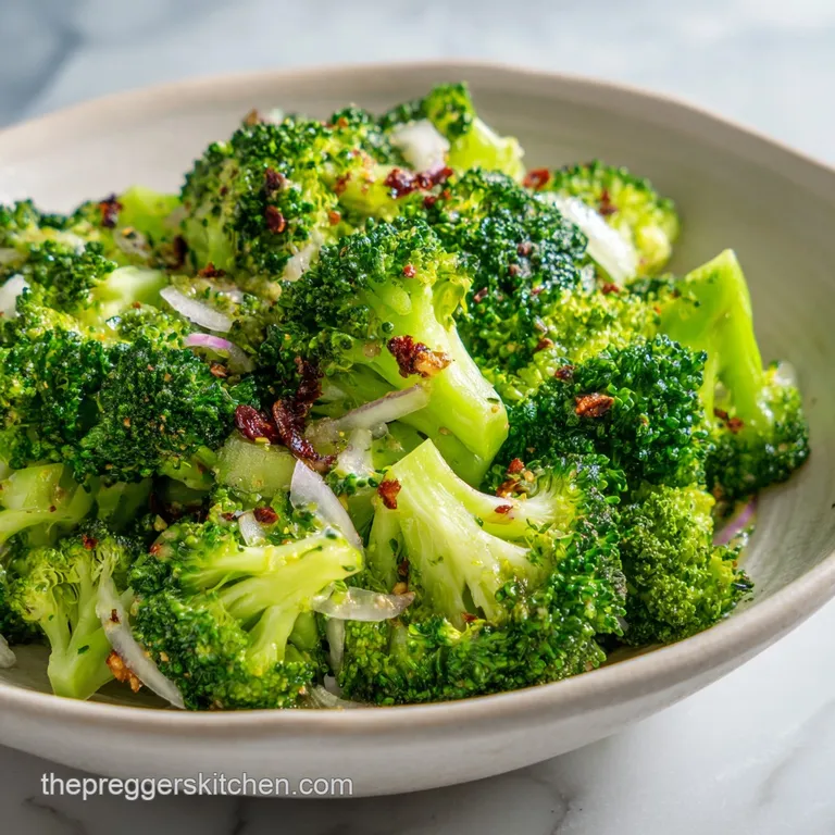 Bright green broccoli salad artfully arranged on a white plate, highlighting the textures of broccoli florets and sliced a...